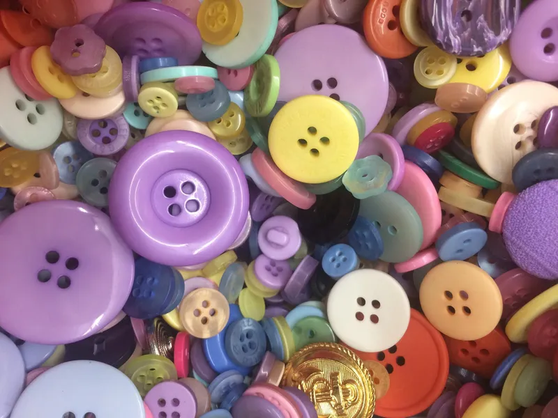 A bowl of donated buttons in mixed colours and sizes