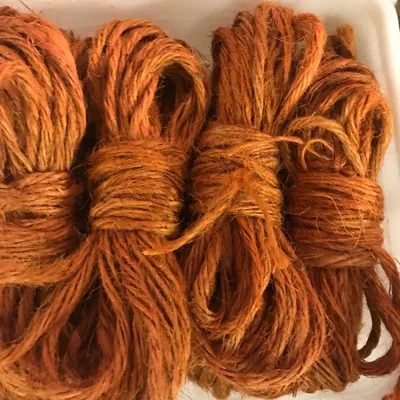 Hanks of donated orange and rust twine