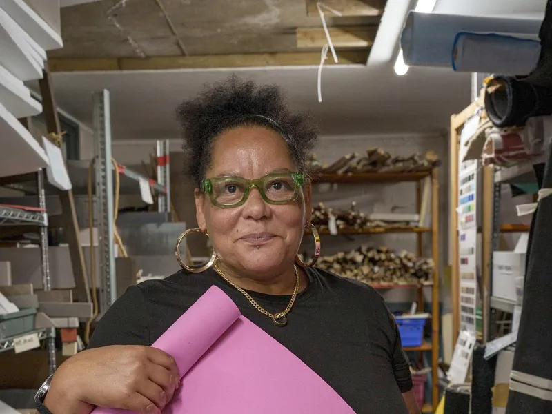 A member unrolling a length of pink paper in the store