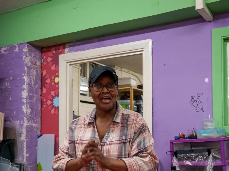A volunteer greeting someone at the store counter
